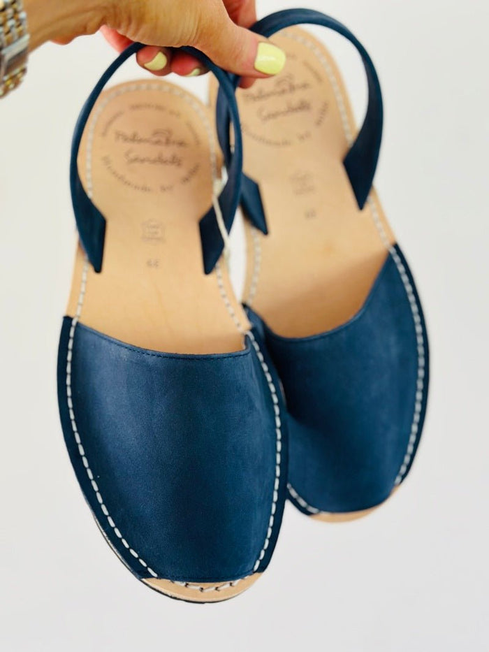 navy nubuck sandals being held