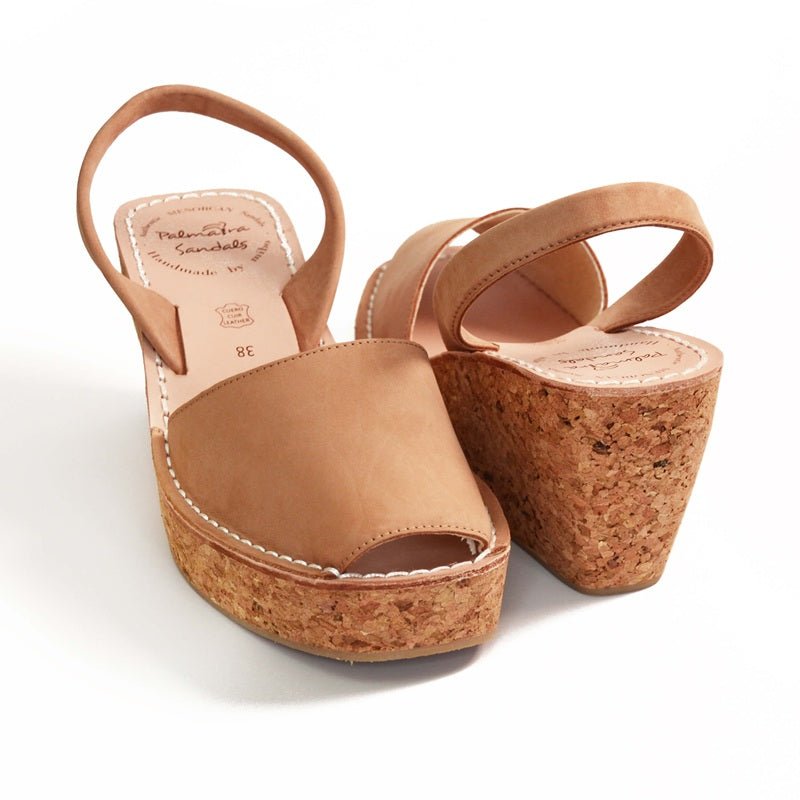Tan wedge sandals with cork sole on a white background