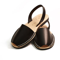 Pair of black leather sandals on a white background