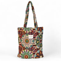 A canvas tote bag featuring a vibrant, multicolour bohemian floral and geometric pattern,