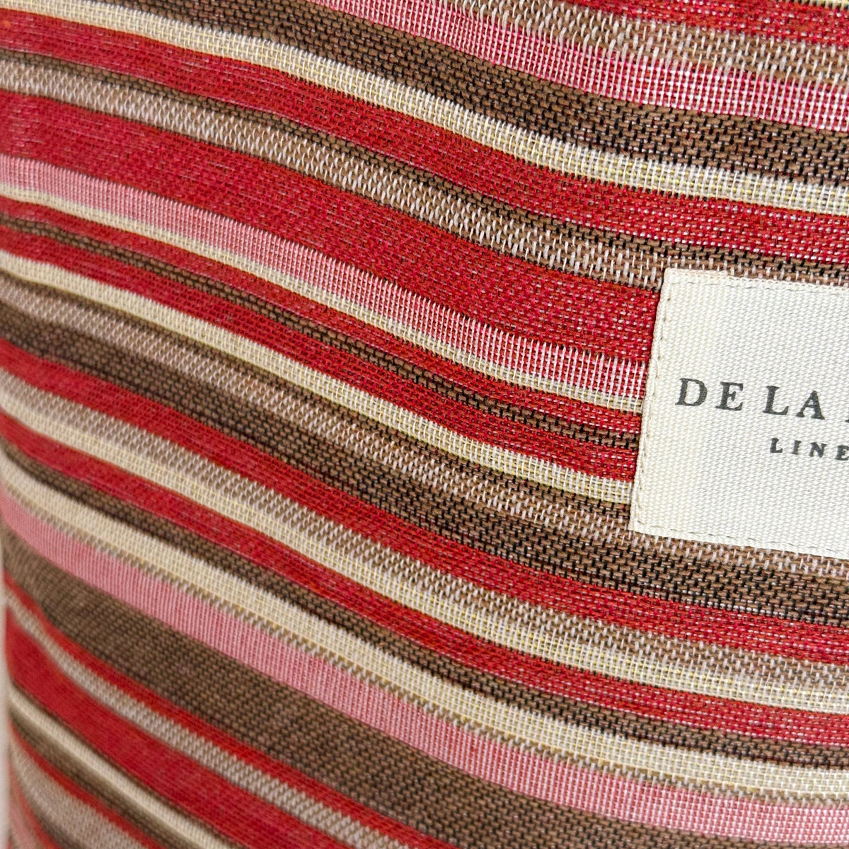 Close-up of striped fabric with a visible brand label.
