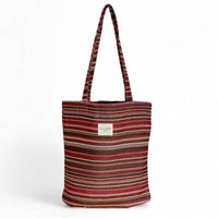 Striped tote bag with a visible brand label on a white background