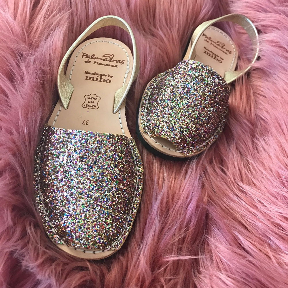 Pair of glittery shoes on a pink fluffy surface