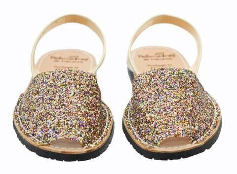 Pair of glittery sandals on a white background