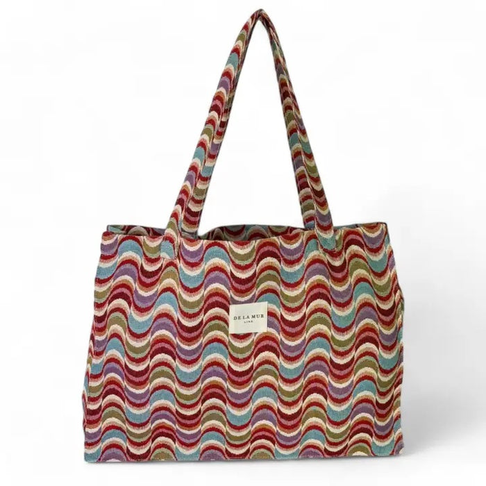 Multicolored wavy patterned tote bag on a white background