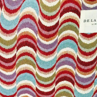 Multicolored wavy pattern fabric with a brand label in the corner.