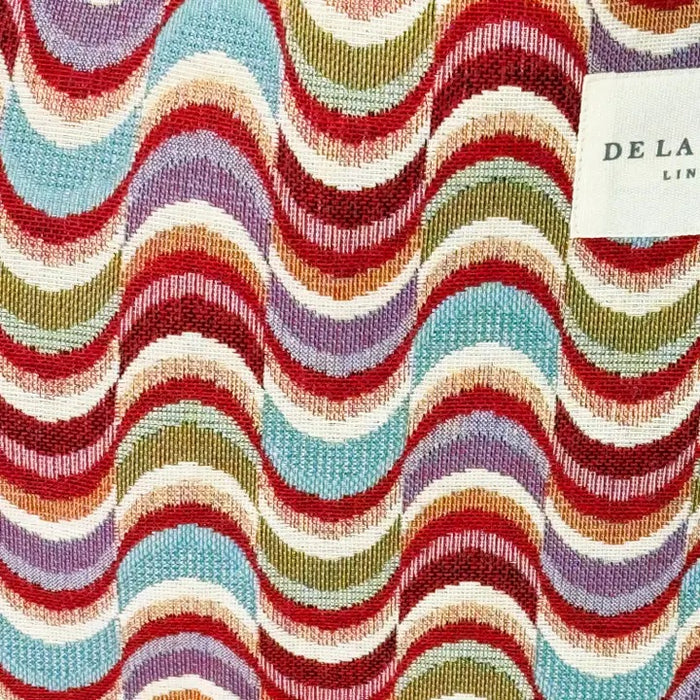 Multicolored wavy pattern fabric with a brand label in the corner.