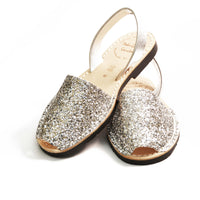 Pair of glittery sandals on a white background