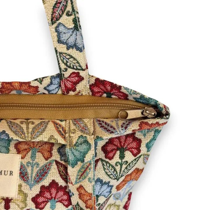 Floral patterned bag with a visible brand label on a white background