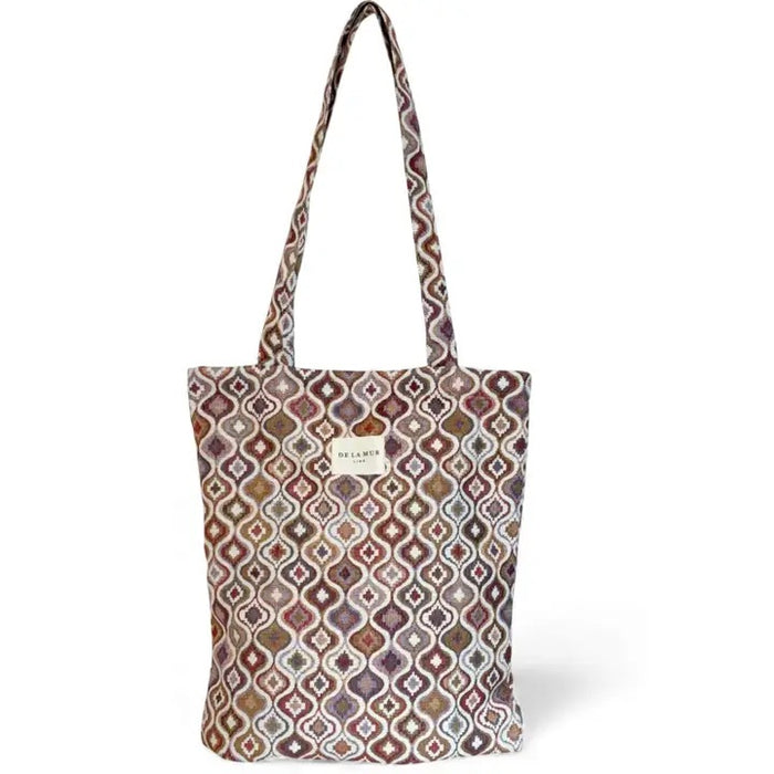 Patterned tote bag with a visible brand label on a white background