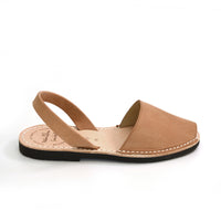 Tan sandal with a black sole on a white background